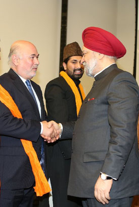 Mr. Granoff shakes hands with Ambassador Singh Puri with Mr. Chishty smiling between them Granoff and Ambassador Singh Puri